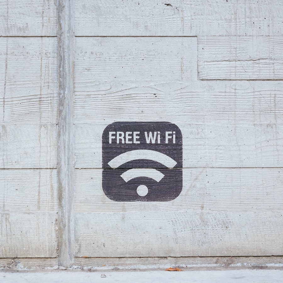 Free Wifi Sign Painted on White Wall